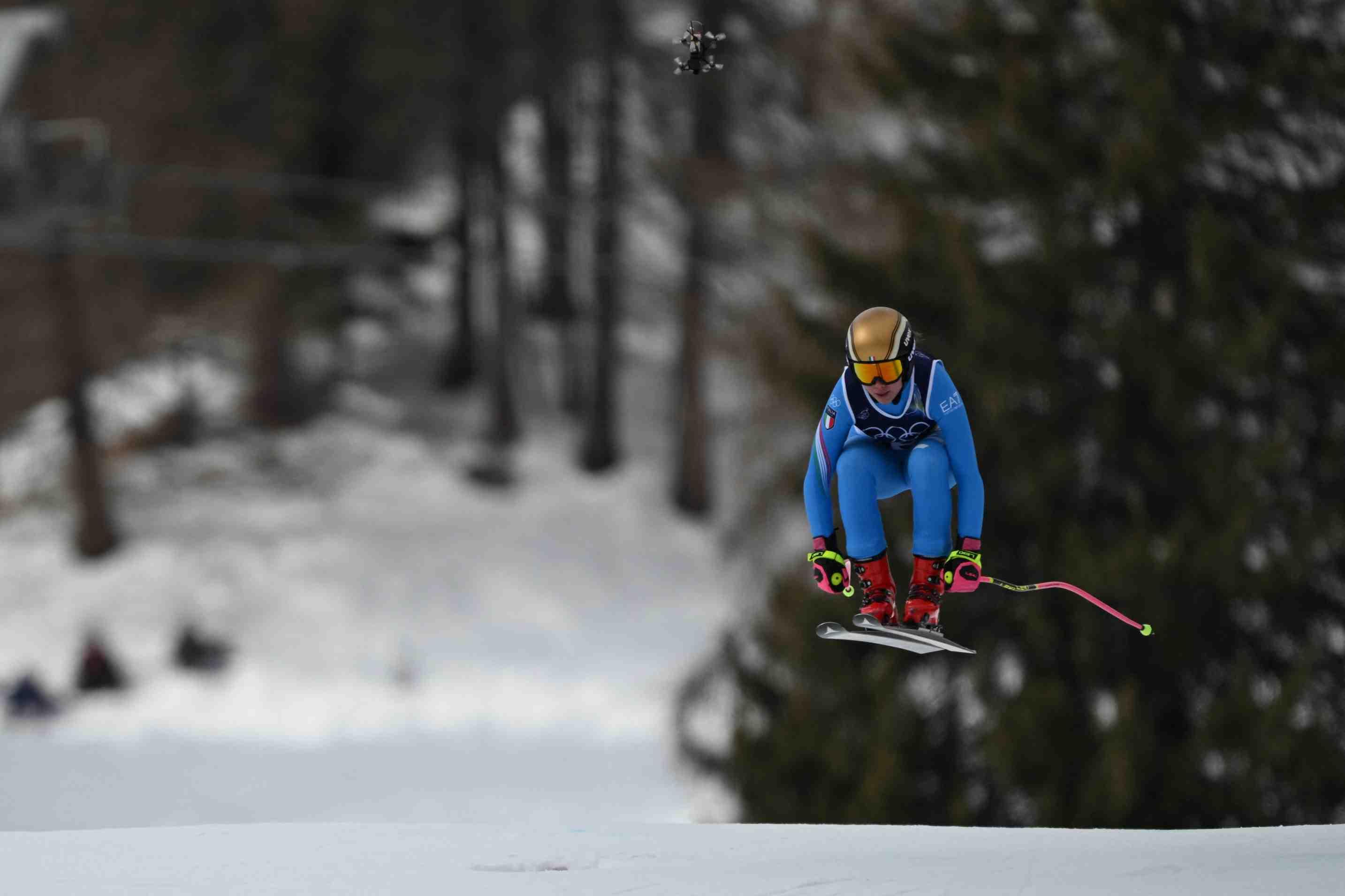 An Italian Olympic skier is pictured midair on the Tofane Alpine Skiing Centre course in Cortina, Italy on Feb. 10 at the 2026 Winter Olympic Games.