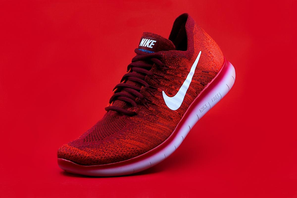 red Nike sneakers on red background