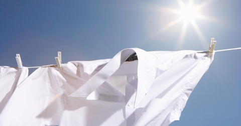 White dress shirts hang on a line to air dry on a sunny day