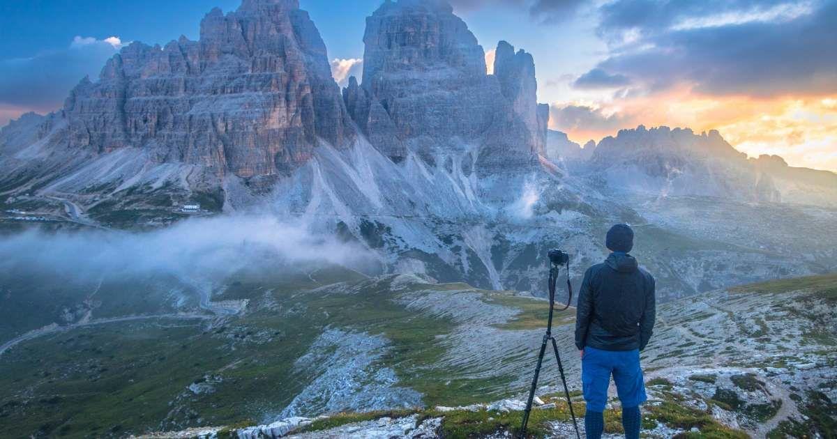 A tourist capturing the scenic view of the Dolomites mountains. (Representative Cover Image Source: Getty Images | Feng Wei Photography)