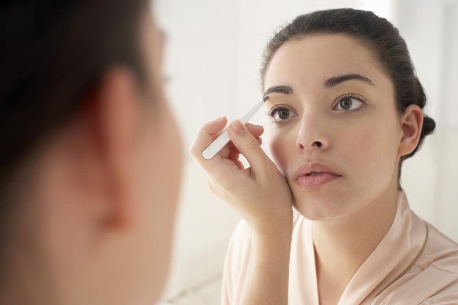 Applying eyeliner