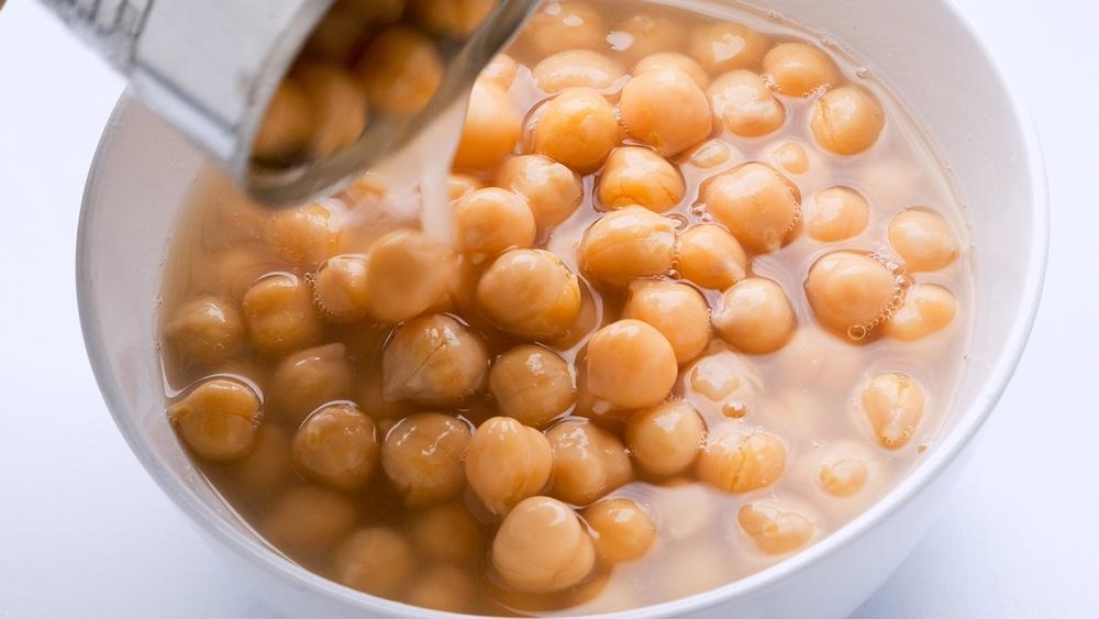 Photo of chickpeas in  a jar with aquafaba. 