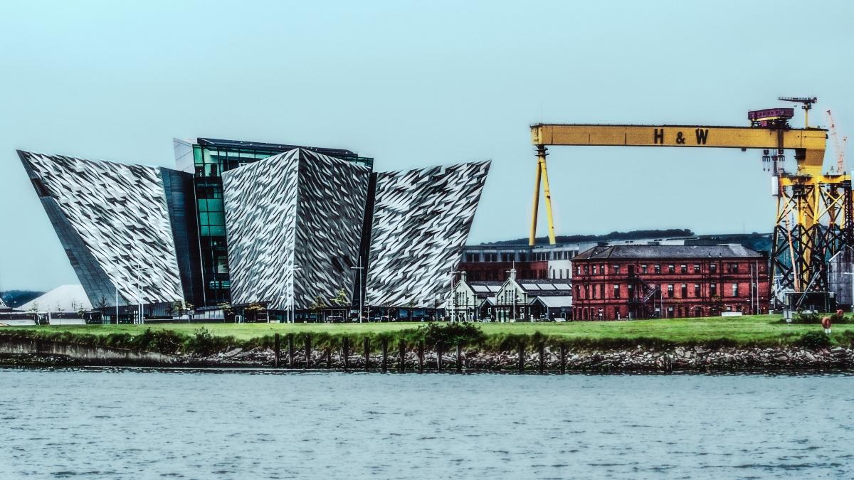 Modern building of Titanic Museum next to a crane.