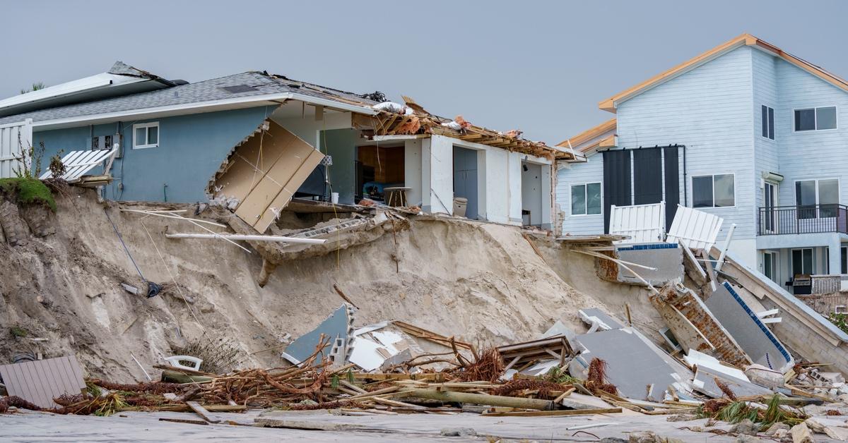 Houses along the beach collapsed and destroyed by hurricane winds.