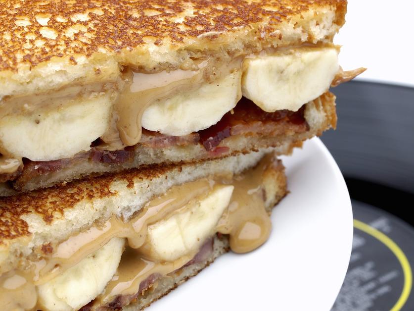 A close up photo of a grilled and sliced peanut butter and banana sandwich.