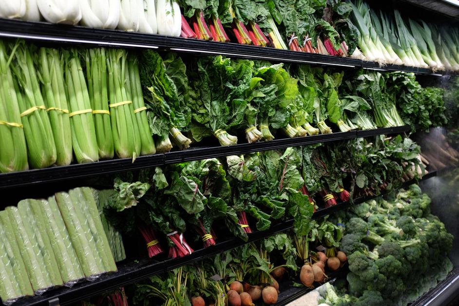 Photo of the organic vegetable aisle in a grocery store. 