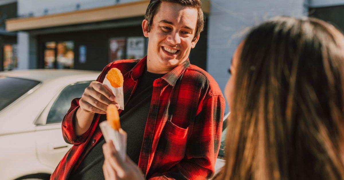 A man and a woman eating a hashbrown (Representative Cover Image Source: Pexels | RDNE Stock Project)