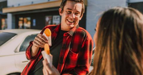 A man and a woman eating a hashbrown (Representative Cover Image Source: Pexels | RDNE Stock Project)