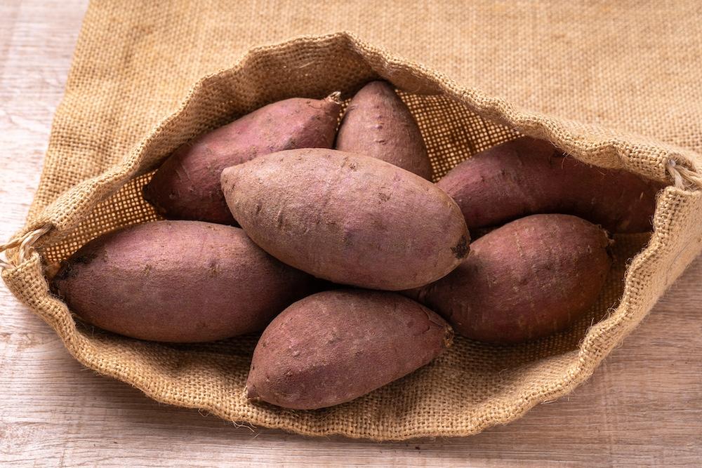 Uncut sweet potatoes in a sack. 