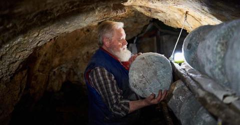 An aged farmer is arranging artisan cheese for curing in a cave. (Representative Cover Image Source: Getty Images | Abraham Gonzalez Fernandez)