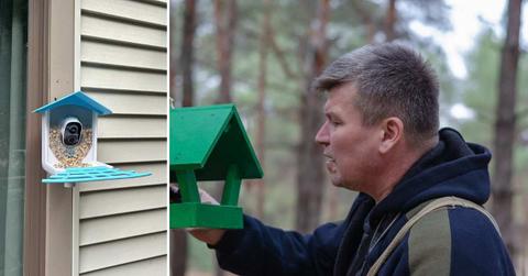 (L) A bird feeder installed on a door (Cover Image Source: (L) Reddit | u/Lots_Loafs11) | (R) A man checks his bird feeder. (Representative Cover Image Source: Getty Images | Michael Dmitriev)