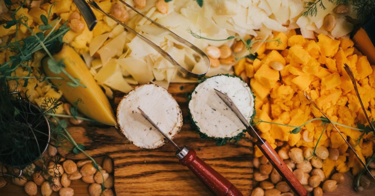 An overhead view of some cheeses, including two wheels of soft cheese