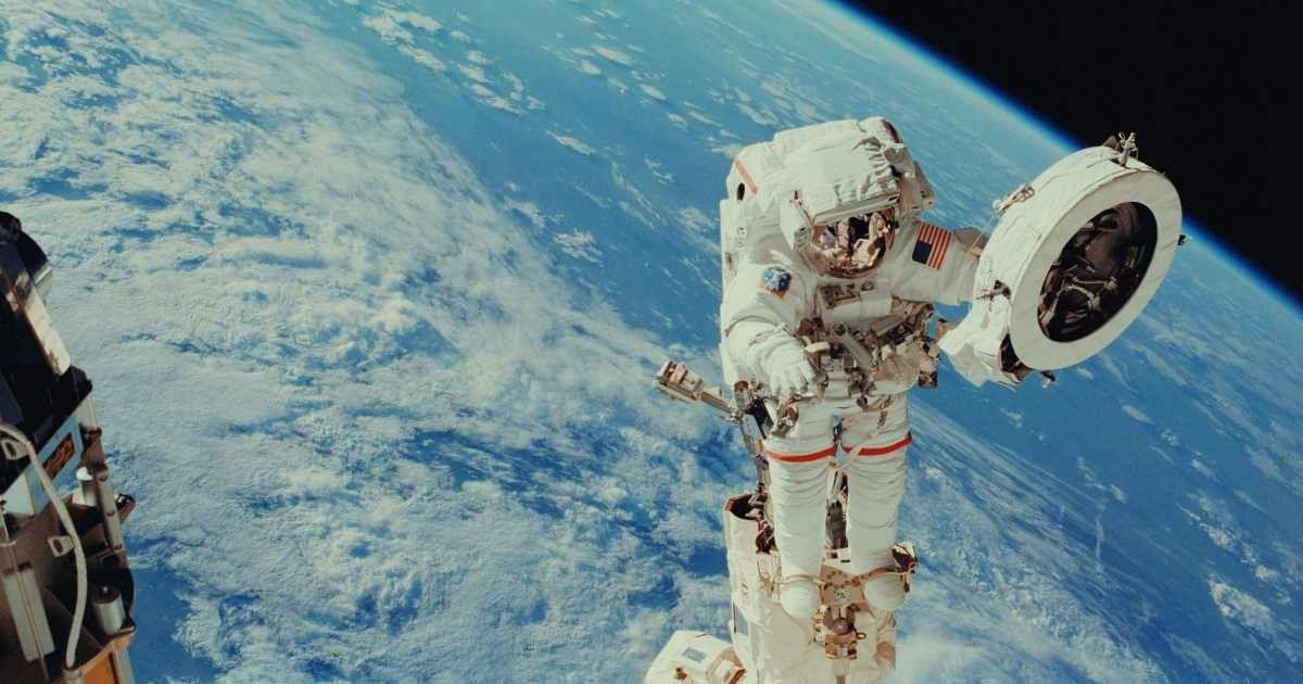 An astronaut doing a spacewalk looks at the Earth. (Representative Cover Image Source: Unsplash | NASA)