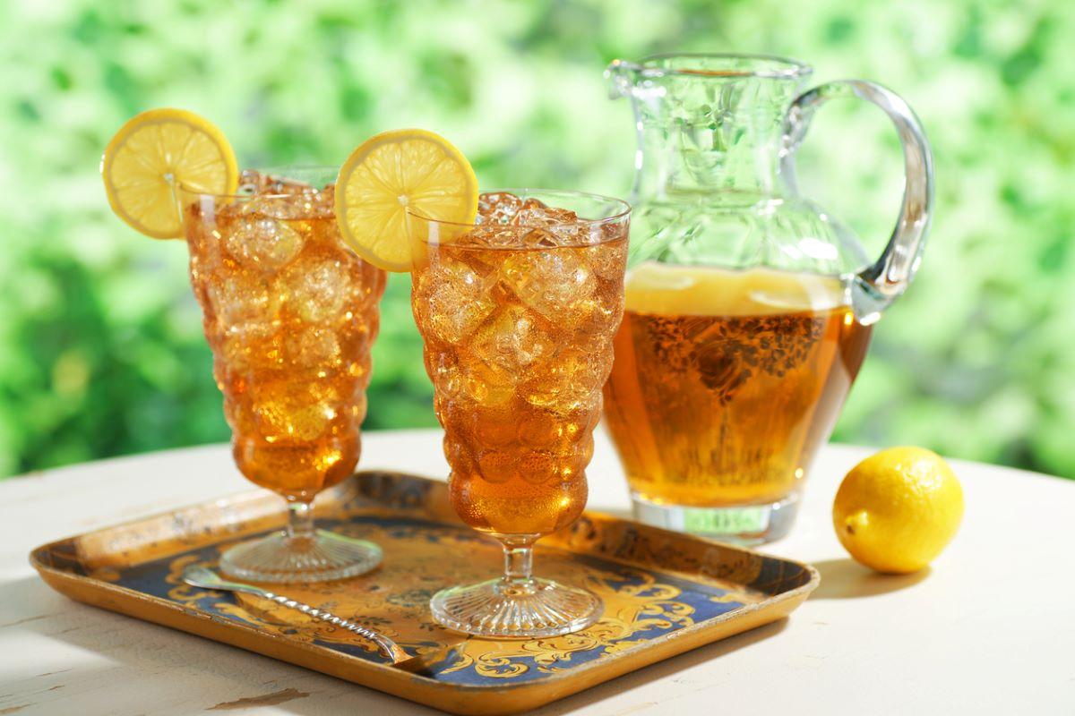 A pitcher and glasses of sweet tea outside