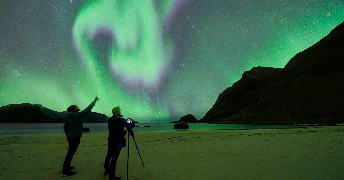 Two people looking at the Northern Lights. (Representative Cover Image Source: Getty Images | Roberto Moiola)