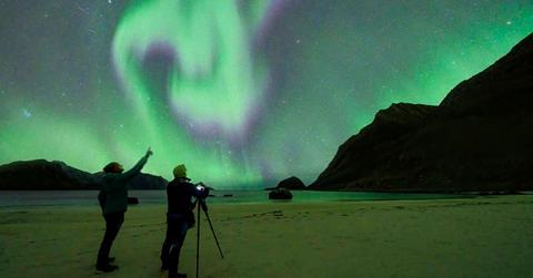 Two people looking at the Northern Lights. (Representative Cover Image Source: Getty Images | Roberto Moiola)
