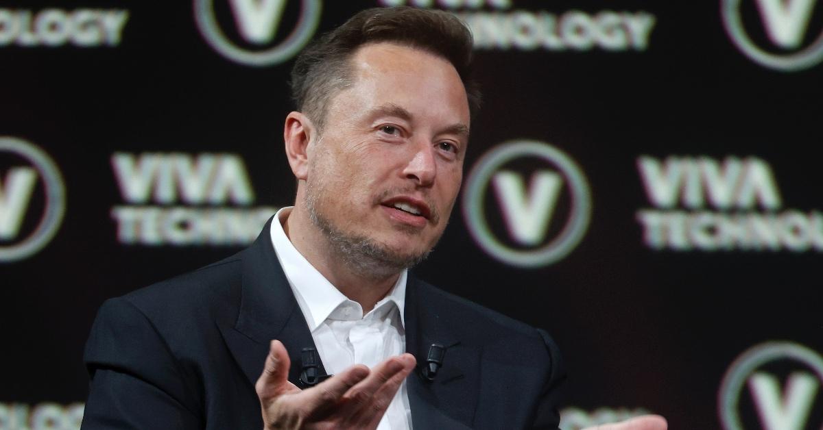 Elon Musk presents at a technology conference. 