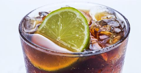 Closeup of a brown soda with a lime in a glass