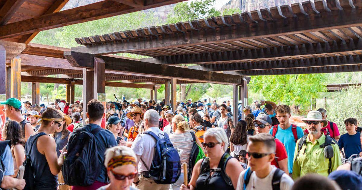 Visitors flocking on a shuttle service in the visitor center in Zion National Park in Utah (Representative Cover Image Source: Getty Images | Krblokhin)