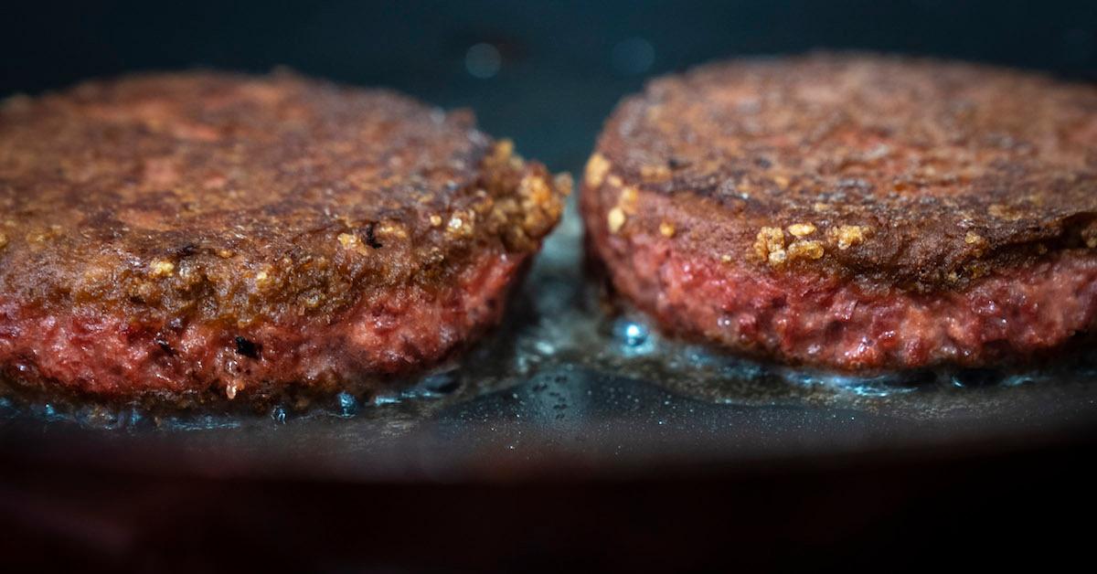 Two plant-based Beyond Burgers on a grill