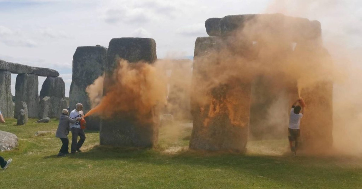 Protesters use an orange paint powder to cover Stonehenge