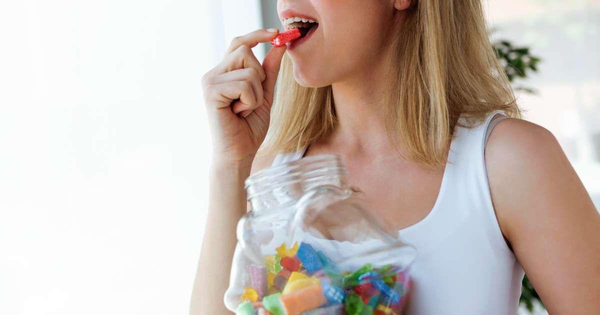A woman is eating a jelly candy from a jar. (Representative Cover Image Source: Getty Images | Nensuria)