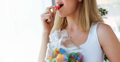 A woman is eating a jelly candy from a jar. (Representative Cover Image Source: Getty Images | Nensuria)