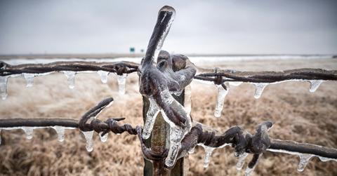 A fence post is frozen in ice