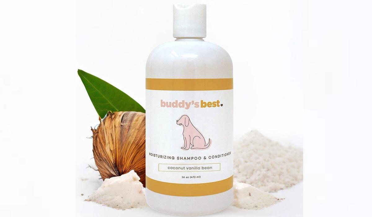 Buddy's Best dog shampoo and conditioner bottle alongside coconut on white background