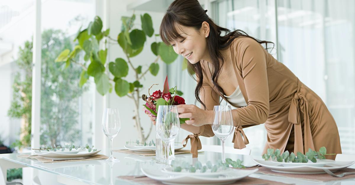 Woman putting plants on her table for dinner. 