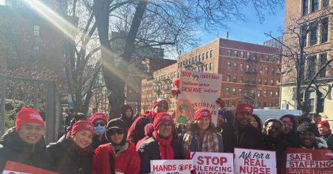 Nurses from the New York State Nurses Association are pictured holding picket signs.