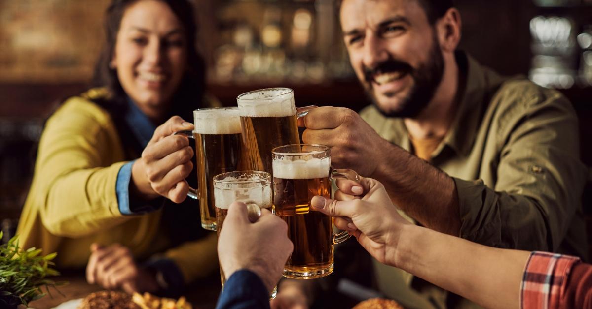 Four people drinking beer together.