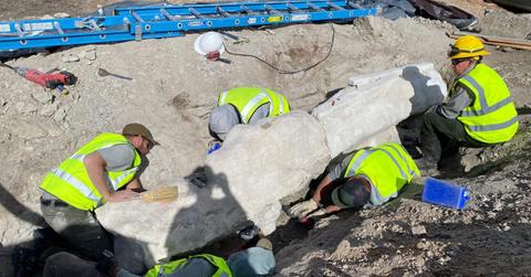 Construction workers in Colorado's Dinosaur National Museum's quarry uncovering a giant sandstone chunk bearing dinosaur fossil (Cover Image Source: National Park Service)