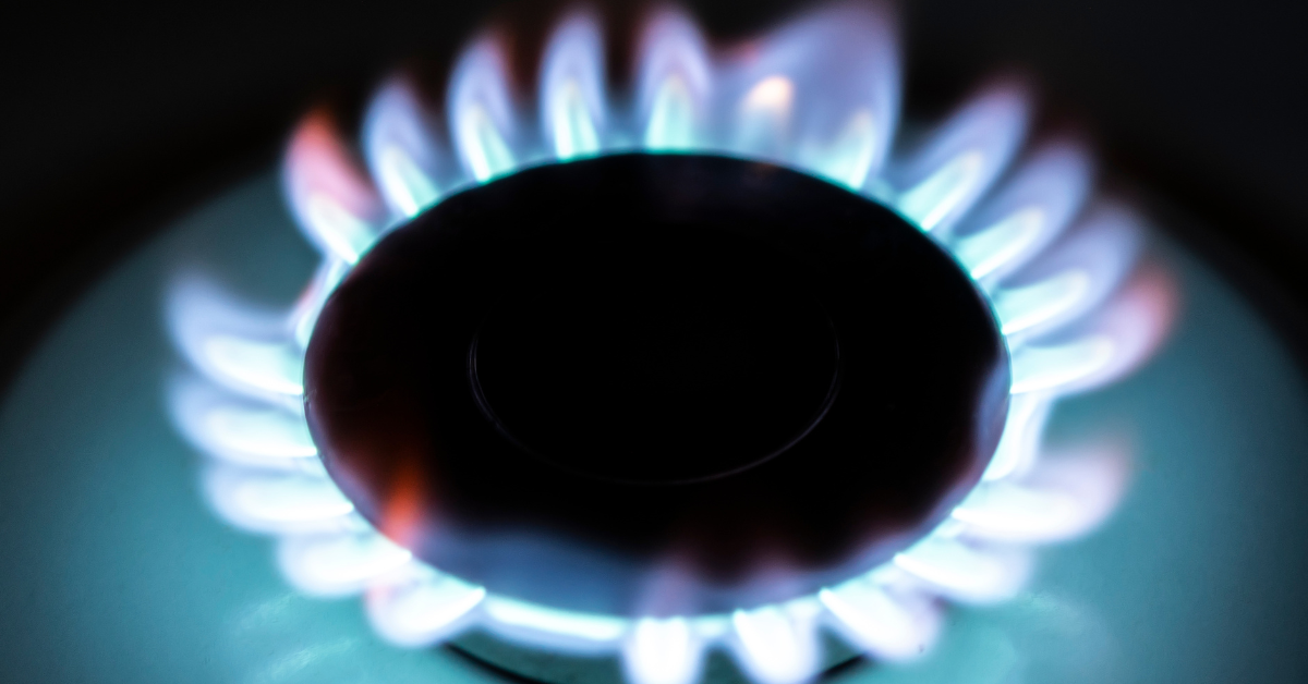 The glow of lit propane gas on a stove