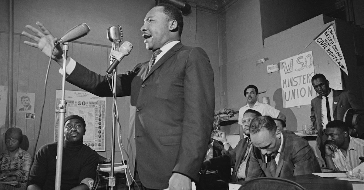 Martin Luther King Jr. addresses a meeting in Chicago in 1966, in a black-and-white image.