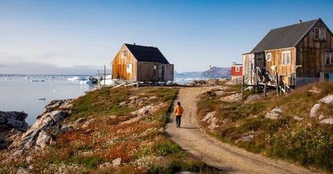 A woman walking on a dirt road in Greenland (Representative Cover Image Source: Getty Images | Onne van der Wal)