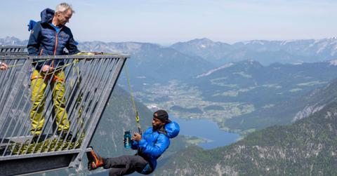 wo people performing extreme climbing.