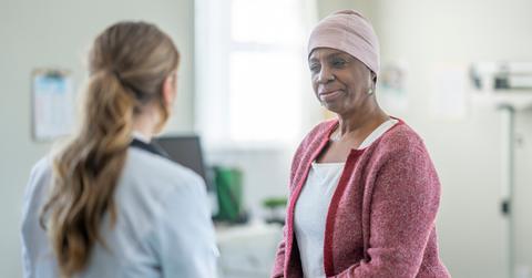 A female oncologist sits across from her Black female cancer patient