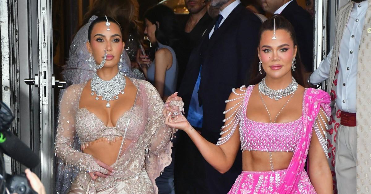 Kim and Khloe Kardashian are dressed in in their interpretation of traditional Indian outfits while attending a wedding in Mumbai