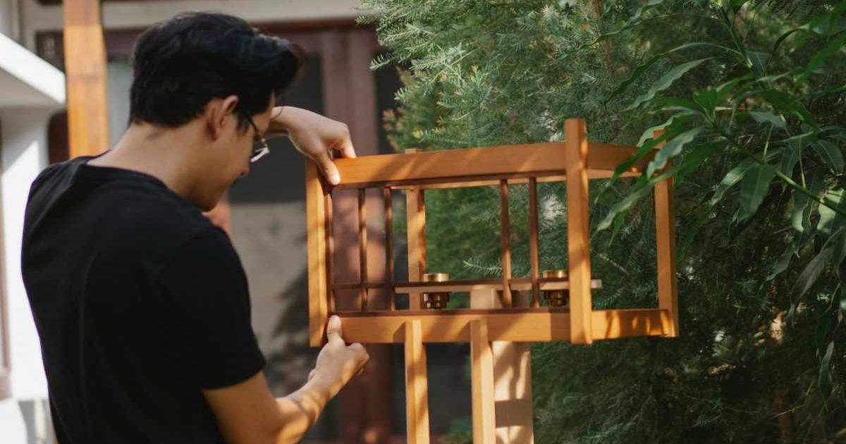 A man is installing a bird feeder in the backyard. (Representative Image Source: Pexels | Ono Kosuki)