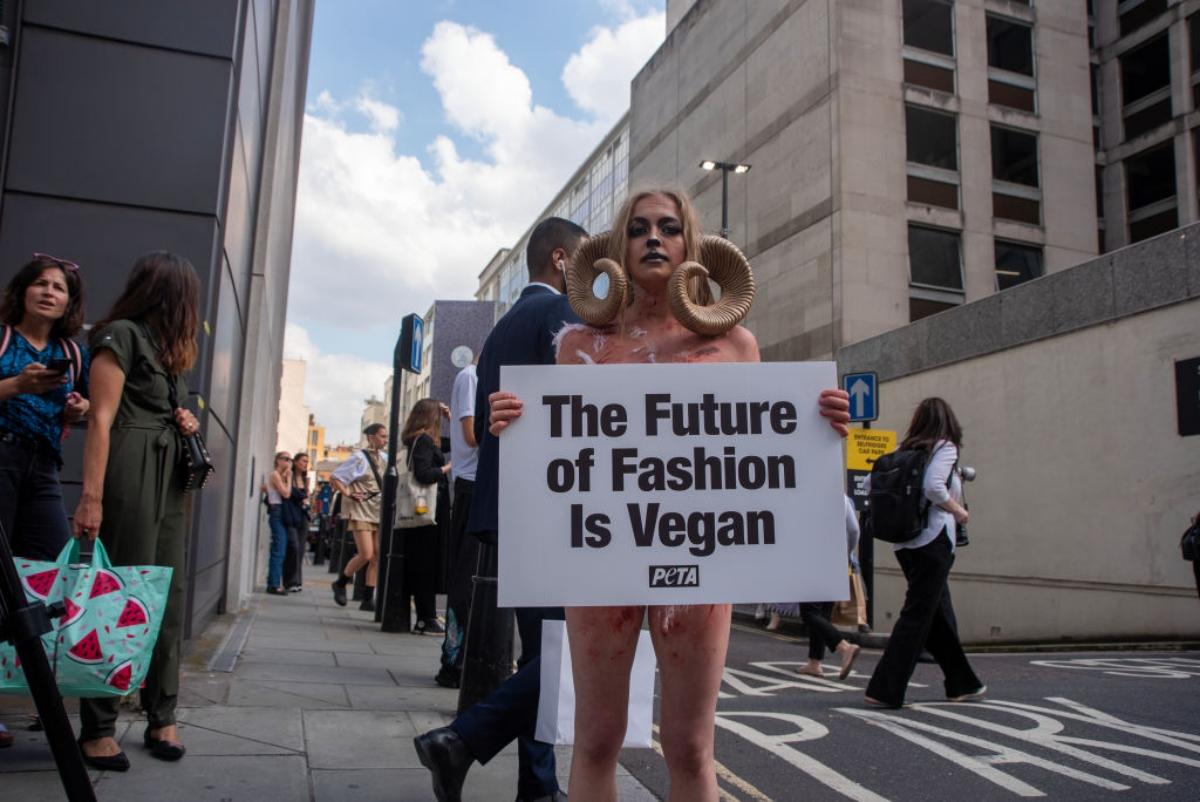 London, England, UK. 23rd Mar, 2022. PETA activists wearing snake costumes  and covered in fake blood were 'skinned alive' outside the Louis Vuitton  store in New Bond Street in protest against the