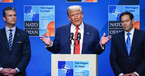 Donald Trump, Marco Rubio, and Pete Hegseth stand behind a NATO podium