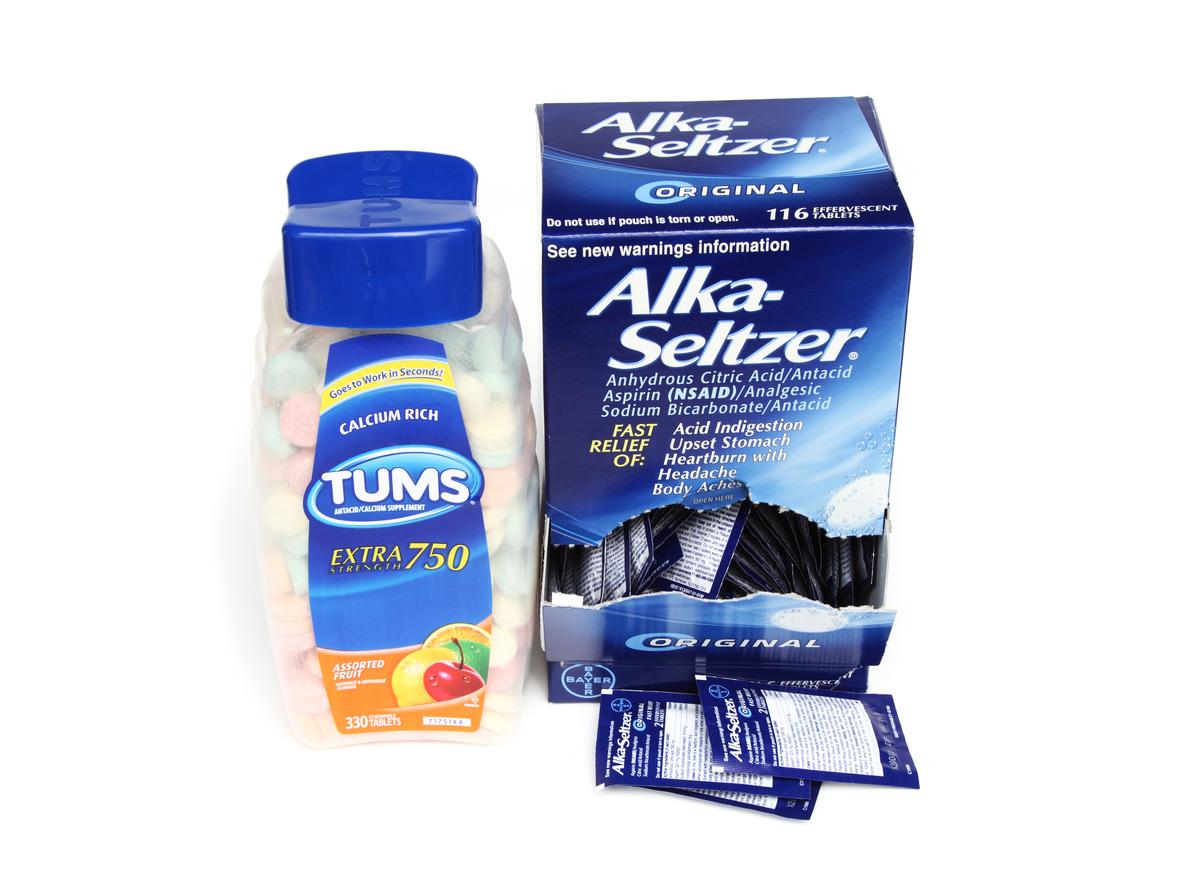 A bottle of Tums and a box of Alka-Seltzer tablets are pictured next to one another.