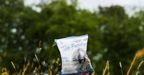 Bag of Two Farmers Crisps in a field