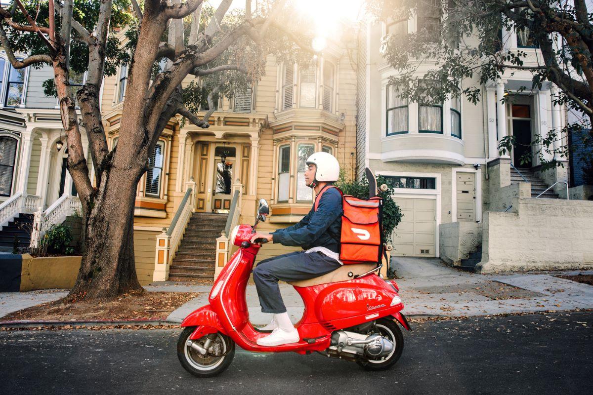 DoorDash delivery driver on a Vespa