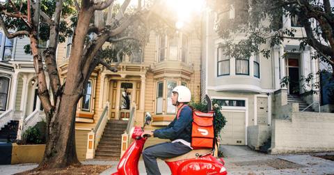 DoorDash delivery driver on a Vespa