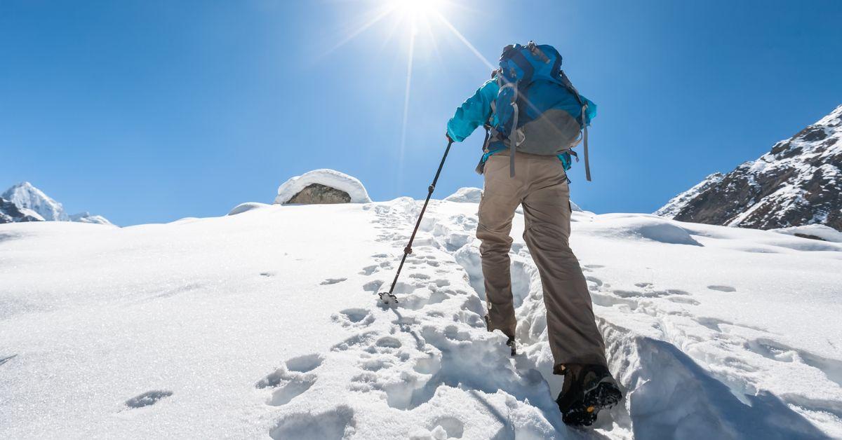 A person hiking Mount Everest in the snow.