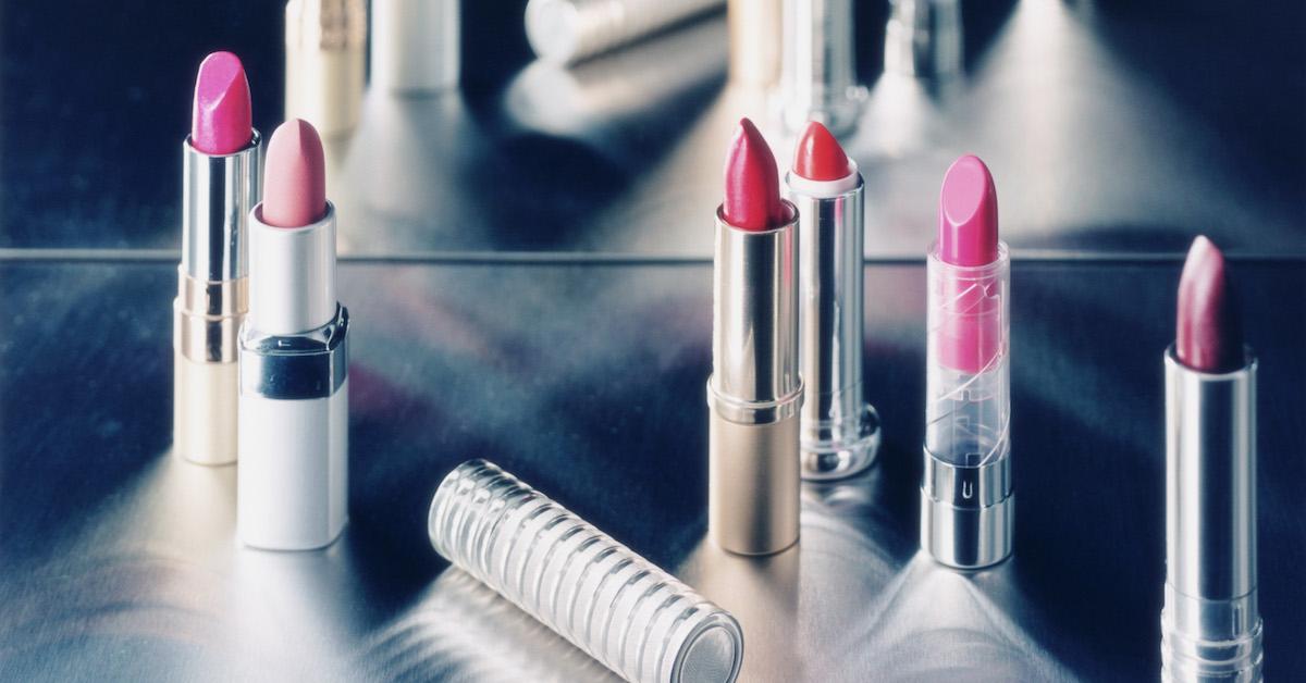 Various pink lipsticks in silver tubes on a silver table