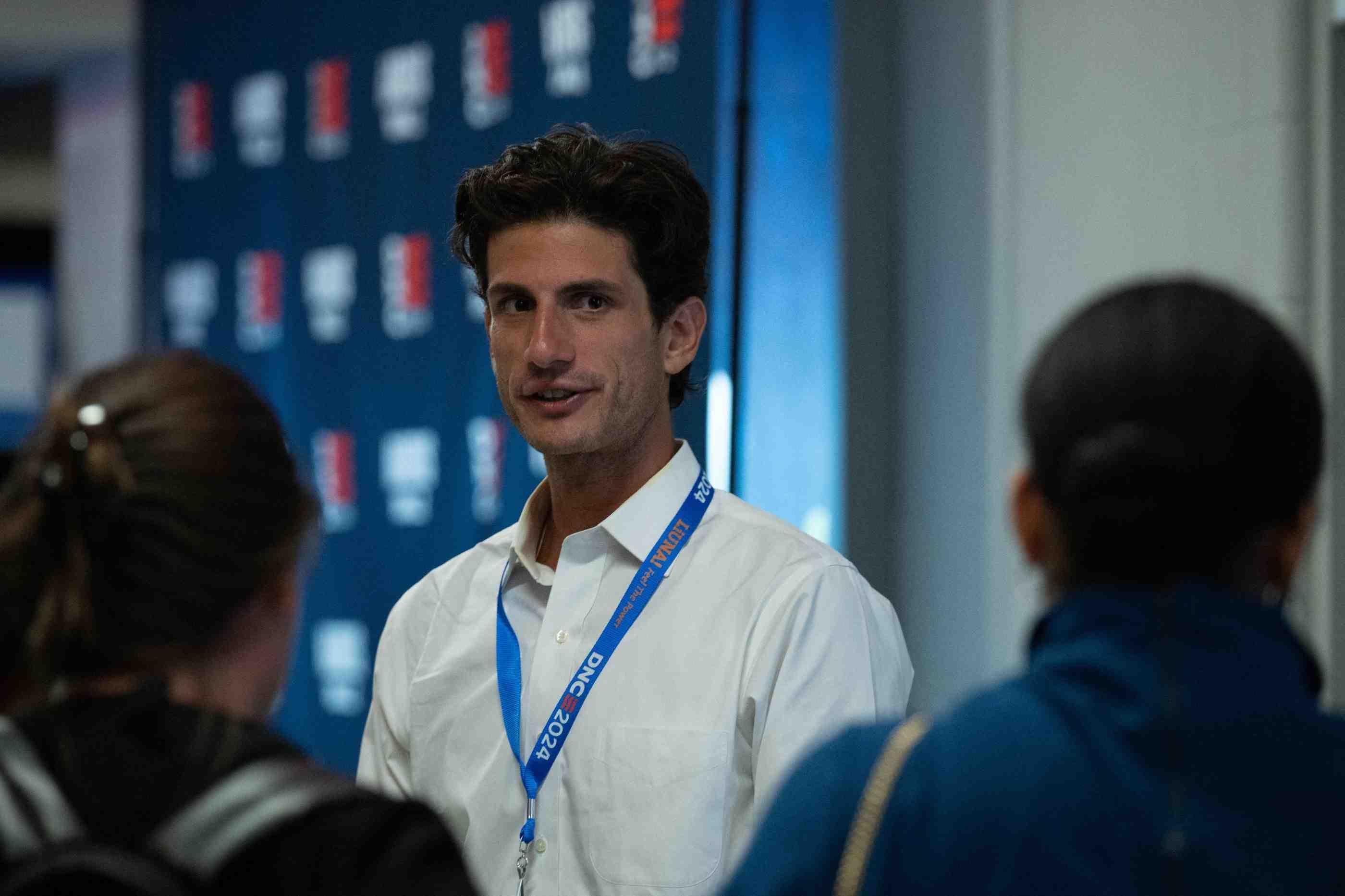 Jack Schlossberg meets with colleagues behind the scenes at the 2024 Democratic National Convention.