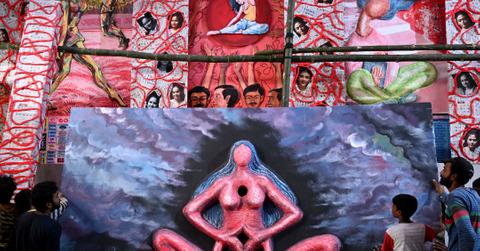 Art work displaying a woman with her hands clasped at her abdomen is pictured at a Pandal in Kolkata